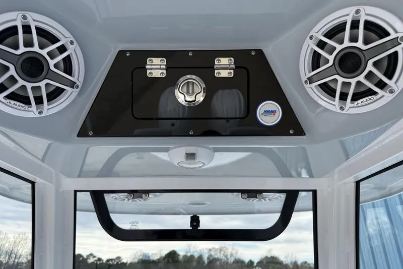 Slide: The Image of 2026 Sportsman Heritage 261 Center Console with JL Audio speakers and storage compartment. - 24