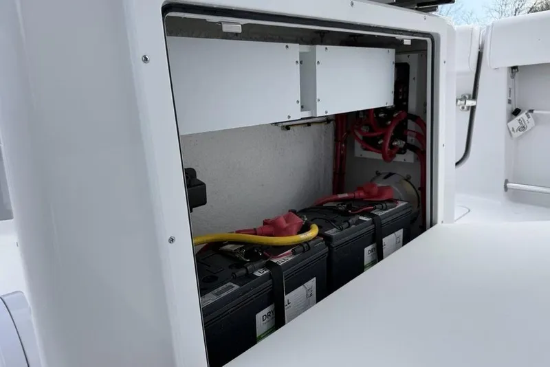 Slide: The Image of Battery compartment of 2026 Sportsman Heritage 261 Center Console boat, showcasing wiring and connections. - 27