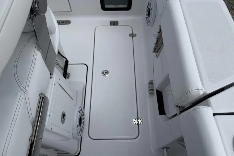 Slide: The Image of Interior view of 2026 Sportsman Heritage 261 Center Console boat, featuring sleek seating and storage. - 28