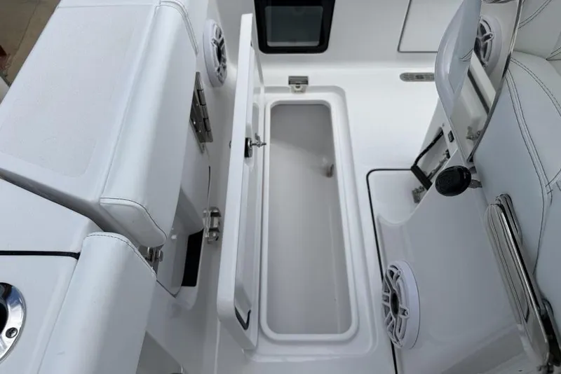 Slide: The Image of 2026 Sportsman Heritage 261 Center Console interior with storage compartment and seating. - 29