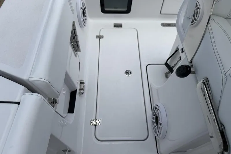 Slide: The Image of Interior view of 2026 Sportsman Heritage 261 Center Console boat, featuring sleek seating and storage. - 32