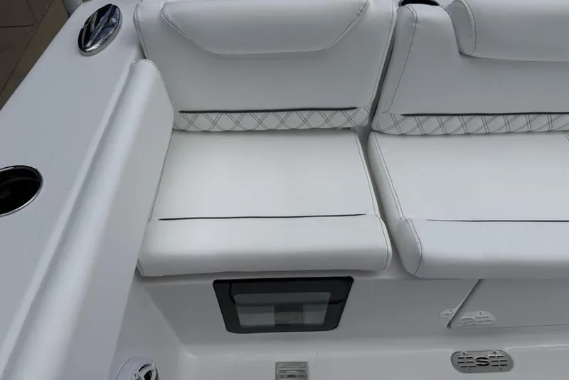 Slide: The Image of 2026 Sportsman Heritage 261 Center Console boat with white cushioned seating. - 35