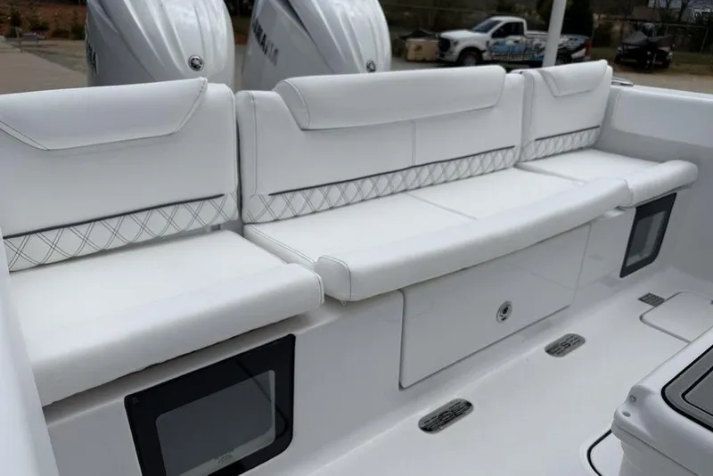 Slide: The Image of White seating on 2026 Sportsman Heritage 261 Center Console boat, featuring elegant design and storage. - 37
