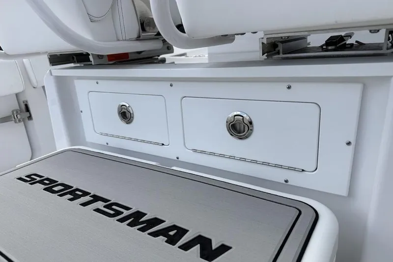 Slide: The Image of 2026 Sportsman Heritage 261 Center Console boat storage compartments and seating detail. - 42