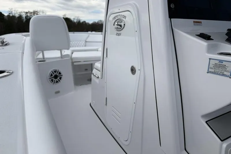 Slide: The Image of 2026 Sportsman Heritage 261 Center Console boat interior, featuring sleek white design and seating. - 44