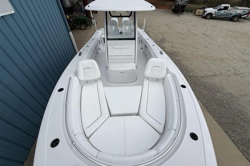 Slide: The Image of 2026 Sportsman Heritage 261 Center Console boat with white seating and console. - 45