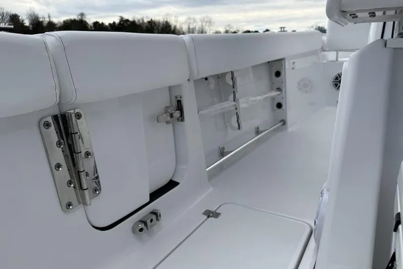 Slide: The Image of 2026 Sportsman Heritage 261 Center Console interior with white seating and storage compartments. - 46