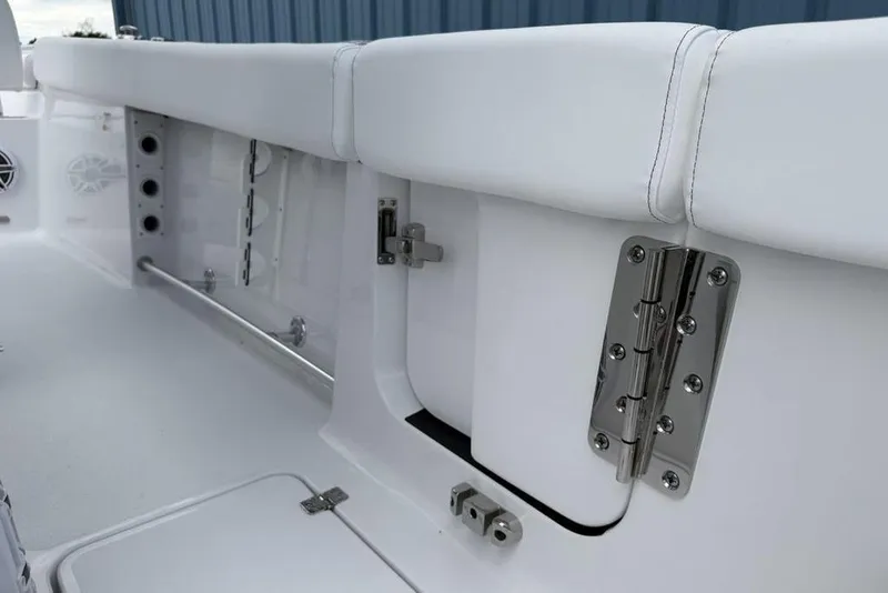 Slide: The Image of 2026 Sportsman Heritage 261 Center Console boat interior with stainless steel hinges and white seating. - 47