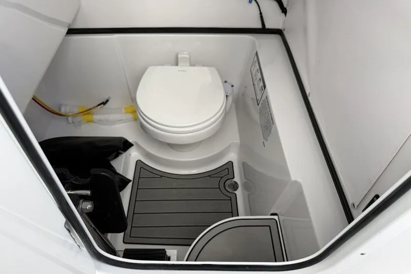 Slide: The Image of Interior of 2026 Sportsman Heritage 261 Center Console boat's compact bathroom. - 48