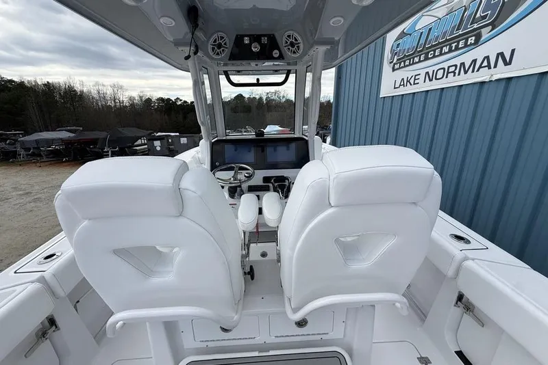 Slide: The Image of 2026 Sportsman Heritage 261 Center Console boat interior with white seating at Lake Norman. - 50