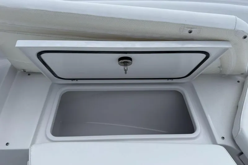 Slide: The Image of Storage compartment on 2026 Sportsman Heritage 261 Center Console boat, open with visible latch. - 6