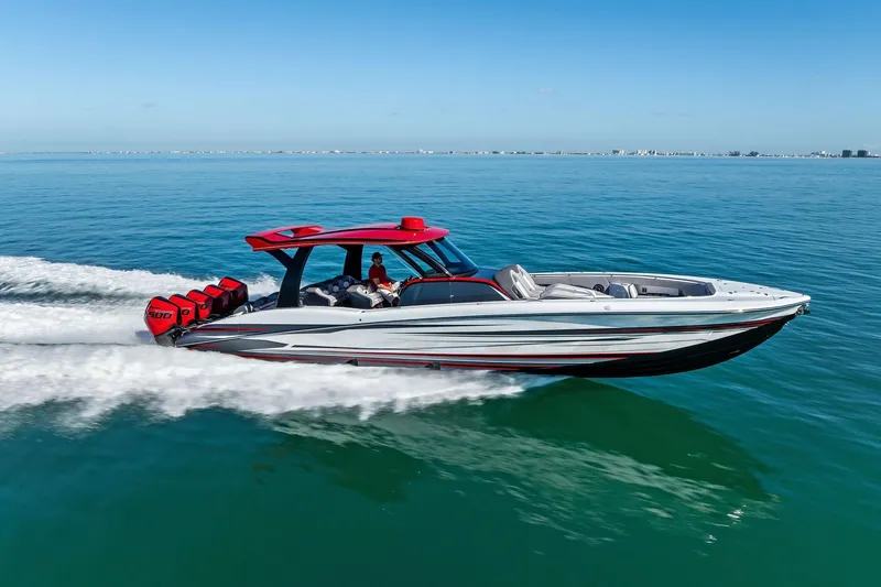 The Image of 2024 MTI V42 speedboat cruising on clear blue water, showcasing sleek design and powerful engines. - 1