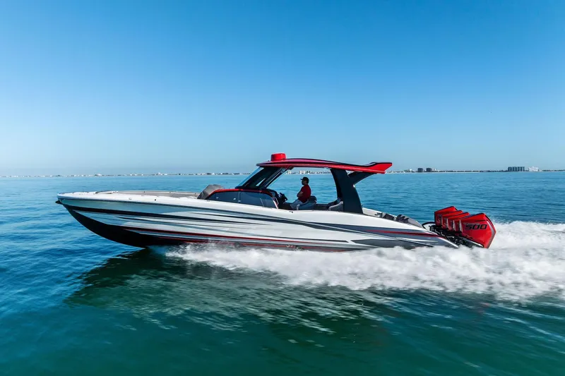 Slide: The Image of 2024 MTI V42 speedboat cruising on open water under clear blue skies. - 10