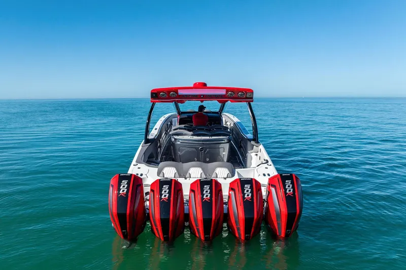 Slide: The Image of 2024 MTI V42 boat with five powerful outboard engines on open water. - 11