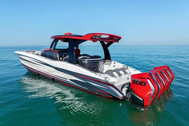 Slide: The Image of 2024 MTI V42 boat with red accents and powerful outboard engines on calm water. - 12