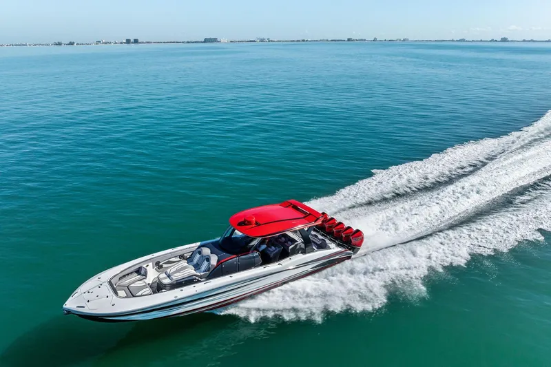 Slide: The Image of 2024 MTI V42 speedboat cruising on open water with red accents. - 13