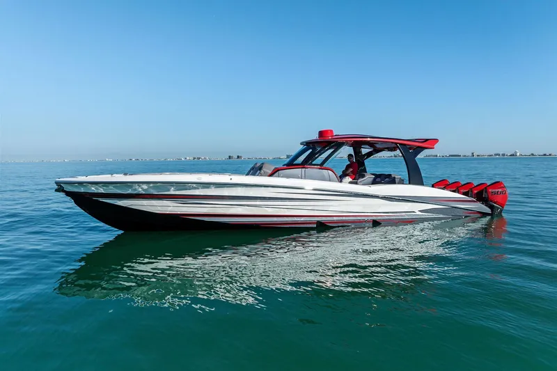 Slide: The Image of 2024 MTI V42 speedboat on calm blue water, featuring sleek design and powerful engines. - 14