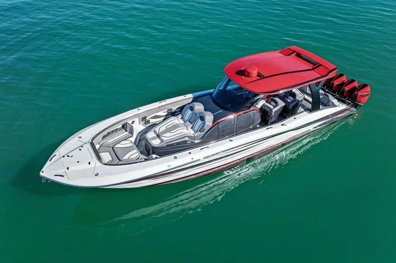 Slide: The Image of 2024 MTI V42 luxury speedboat with red accents cruising on clear blue water. - 16