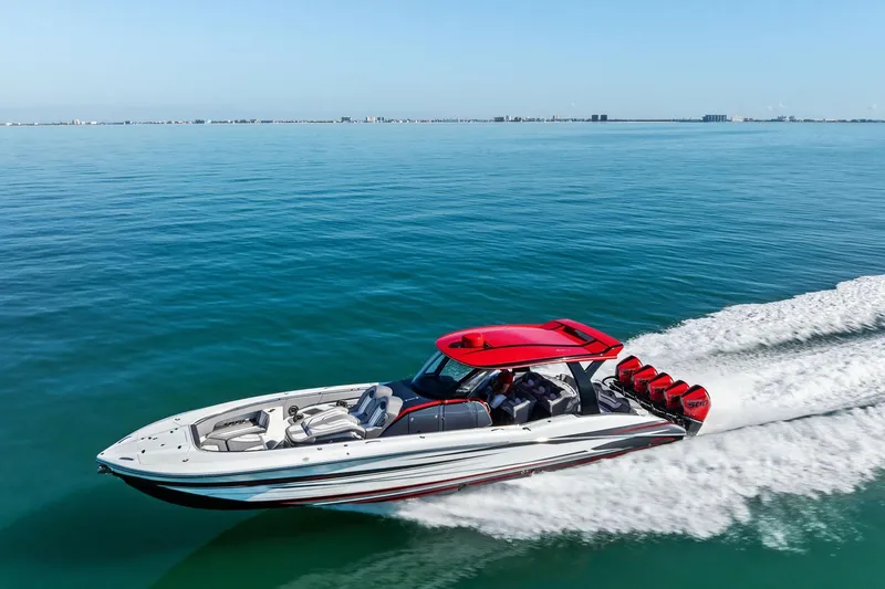 Slide: The Image of 2024 MTI V42 speedboat with red accents cruising on open water. - 18