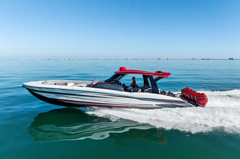 Slide: The Image of 2024 MTI V42 speedboat cruising on calm blue waters, featuring red accents and powerful engines. - 19
