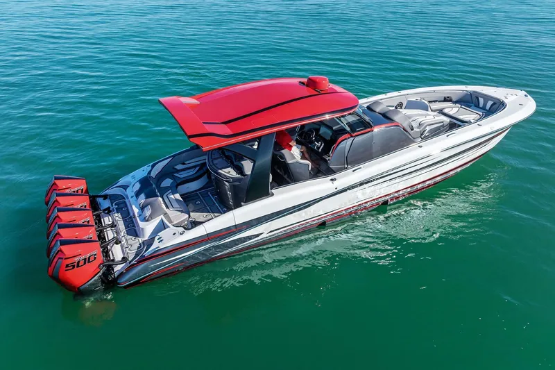 Slide: The Image of 2024 MTI V42 boat with red accents and quad engines on clear water. - 23