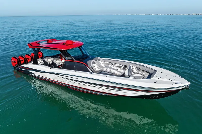 Slide: The Image of 2024 MTI V42 luxury speedboat with red accents on calm ocean water. - 24