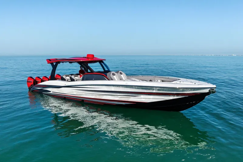 Slide: The Image of 2024 MTI V42 speedboat with red accents on calm blue water. - 26