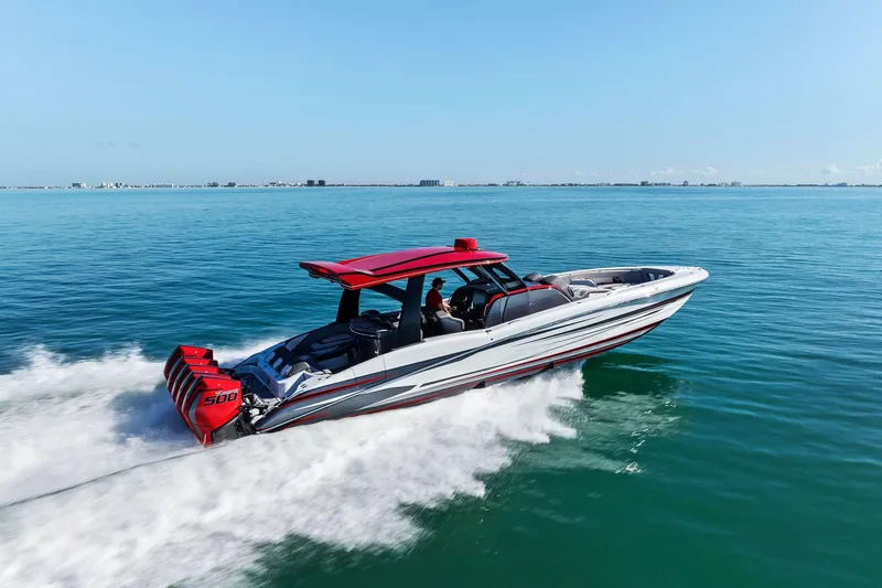 Slide: The Image of 2024 MTI V42 speedboat cruising on open water with red accents and powerful engines. - 27