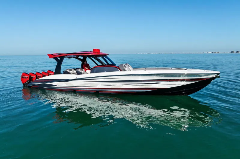 Slide: The Image of 2024 MTI V42 boat with multiple engines cruising on clear blue water. - 28
