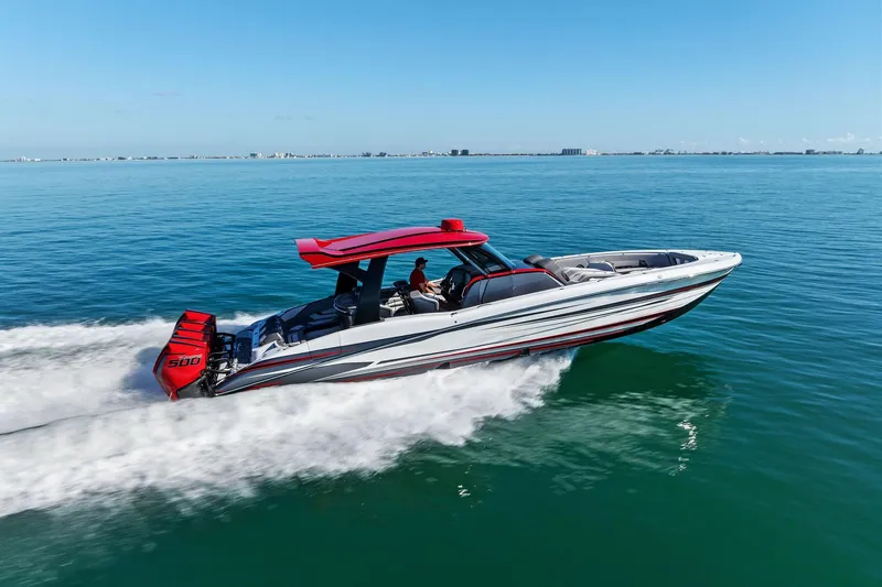 Slide: The Image of 2024 MTI V42 speedboat cruising on open water under clear blue skies. - 29