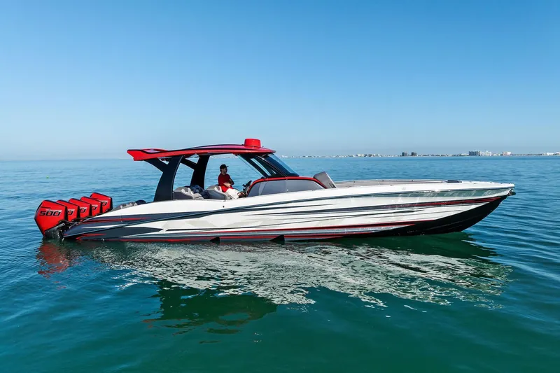 Slide: The Image of 2024 MTI V42 boat cruising on calm ocean waters under clear blue sky. - 30