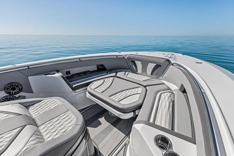 Slide: The Image of Luxurious 2024 MTI V42 boat interior with elegant seating on calm ocean waters. - 32