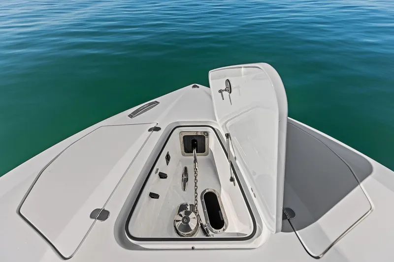 Slide: The Image of Open anchor compartment on 2024 MTI V42 boat, floating on calm blue water. - 35