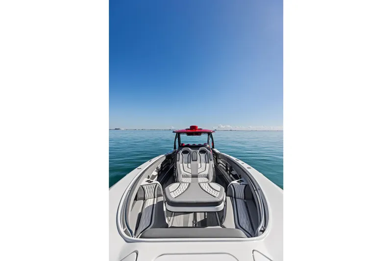Slide: The Image of 2024 MTI V42 boat on calm water under clear blue sky. - 36