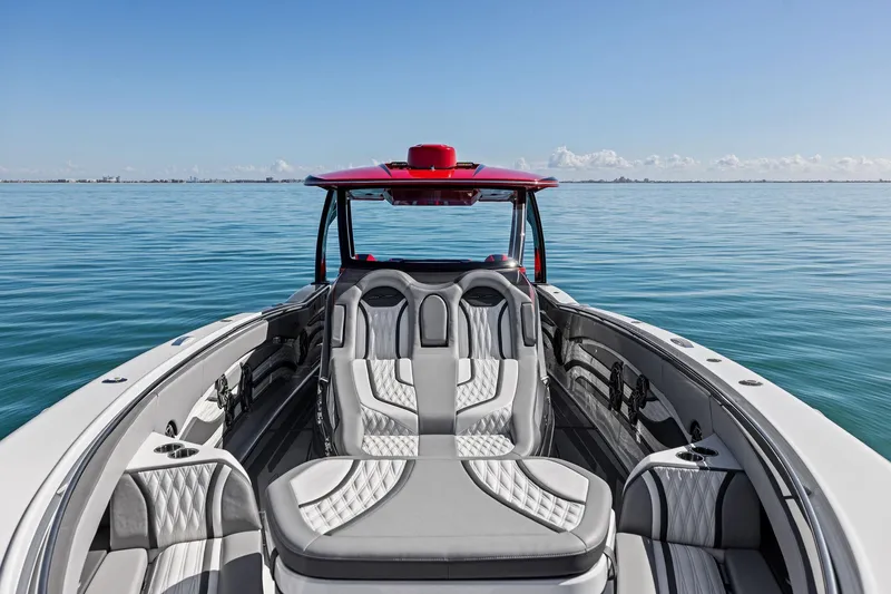 Slide: The Image of 2024 MTI V42 luxury boat with sleek seating on calm water. - 39