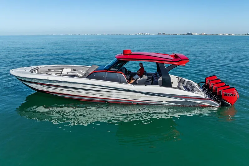Slide: The Image of 2024 MTI V42 boat with red accents and multiple engines on calm water. - 4