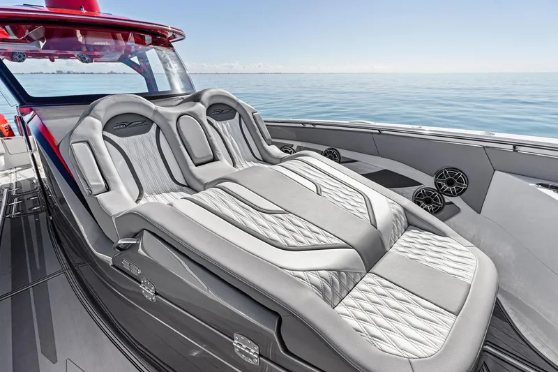 Slide: The Image of 2024 MTI V42 luxury boat with plush seating and sleek design on calm water. - 40