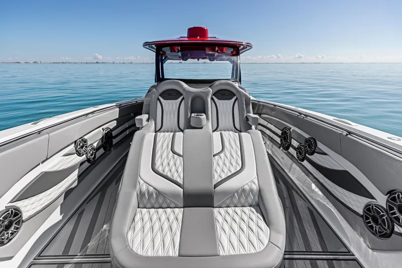 Slide: The Image of Luxury MTI V42 boat interior, 2024 model, featuring sleek seating and ocean view. - 49