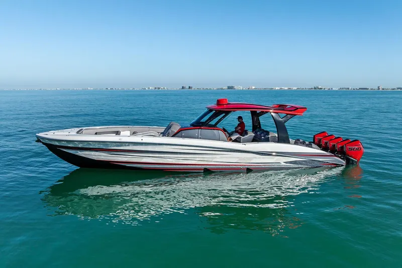 Slide: The Image of 2024 MTI V42 boat on calm blue water, featuring sleek design and powerful engines. - 5