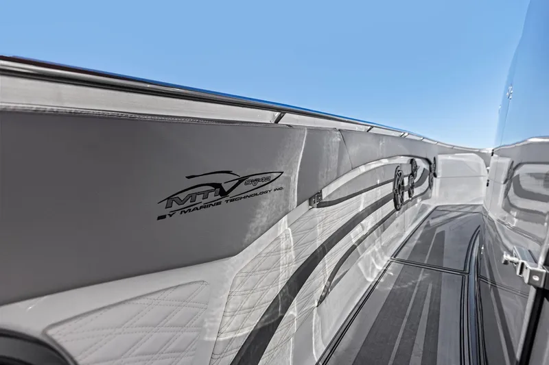 Slide: The Image of 2024 MTI V42 boat interior with sleek design and logo, under clear blue sky. - 51