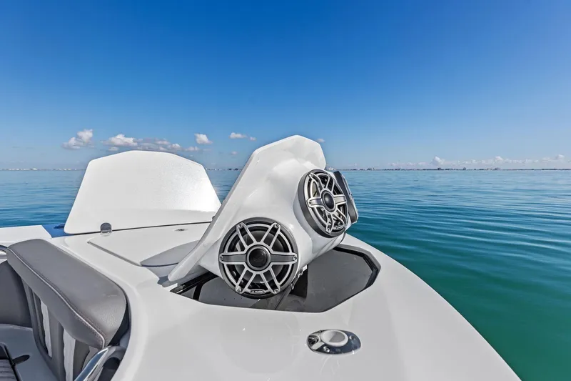 Slide: The Image of 2024 MTI V42 boat with speakers on calm blue water under clear sky. - 55