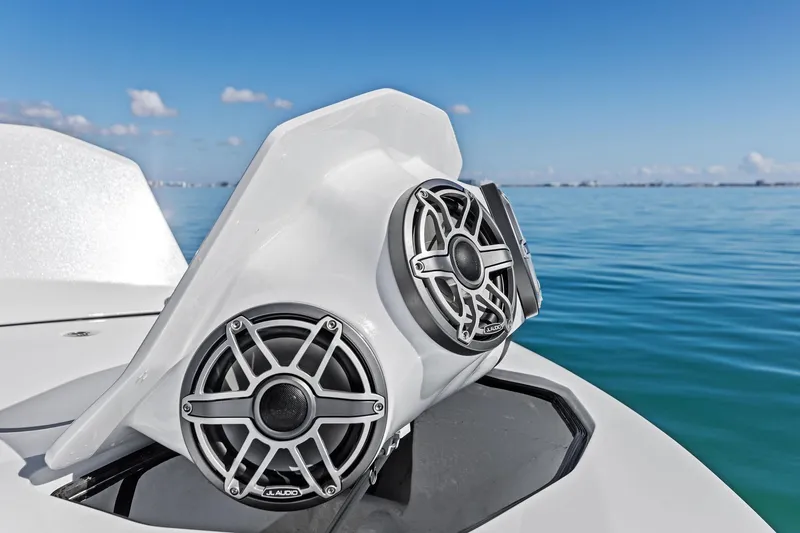 Slide: The Image of 2024 MTI V42 boat with JL Audio speakers on a calm sea. - 56