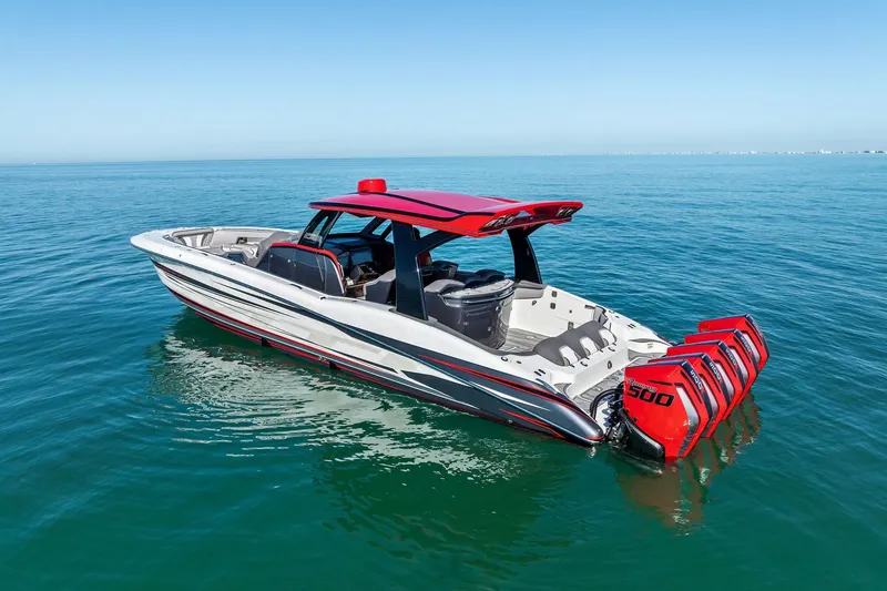 Slide: The Image of 2024 MTI V42 boat with red accents and quad engines on calm blue water. - 6