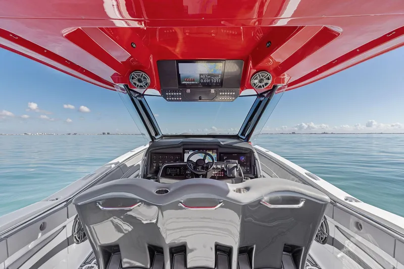 Slide: The Image of Interior view of 2024 MTI V42 boat cockpit with red canopy and modern controls. - 60