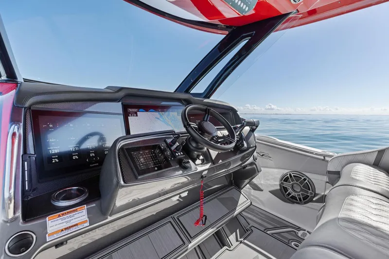 Slide: The Image of 2024 MTI V42 boat cockpit with advanced navigation system and luxurious seating on open water. - 64