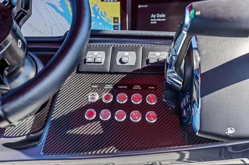 Slide: The Image of Control panel of 2024 MTI V42 boat with carbon fiber finish and navigation controls. - 66