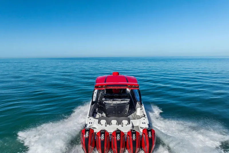 Slide: The Image of 2024 MTI V42 boat with red accents cruising on open water. - 7