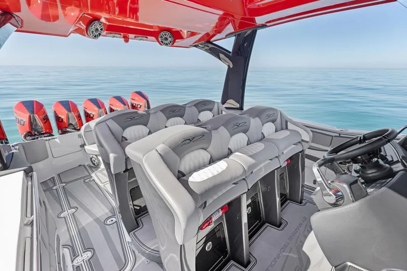 Slide: The Image of 2024 MTI V42 boat interior with luxury seating and multiple outboard engines on calm water. - 72
