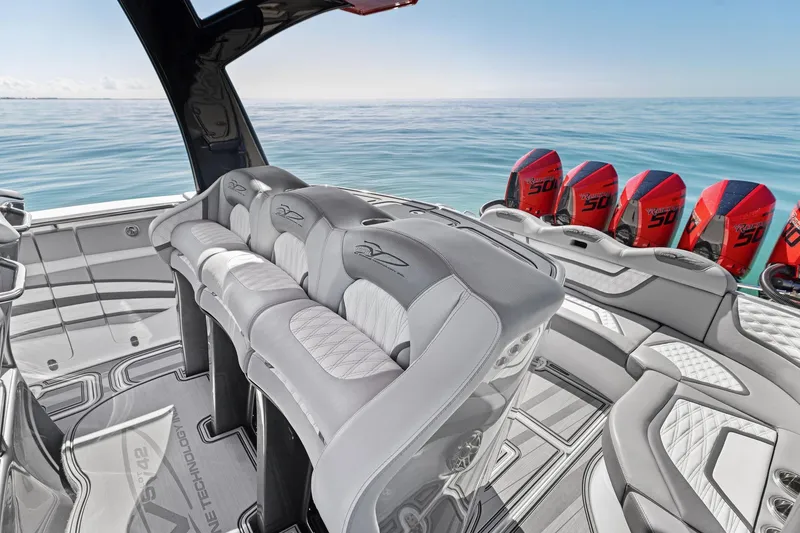 Slide: The Image of Luxury MTI V42 boat interior with plush seating and powerful outboard engines, 2024 model. - 74