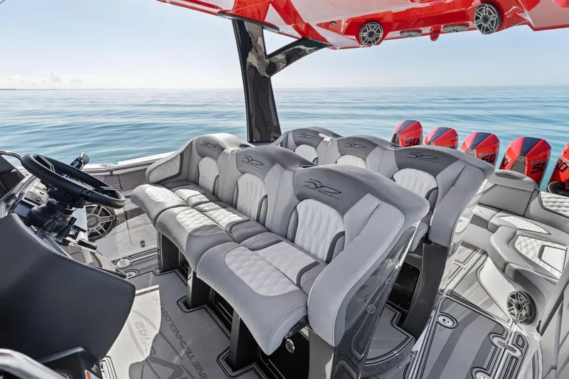 Slide: The Image of 2024 MTI V42 boat interior with luxury seating and multiple outboard engines on open water. - 76